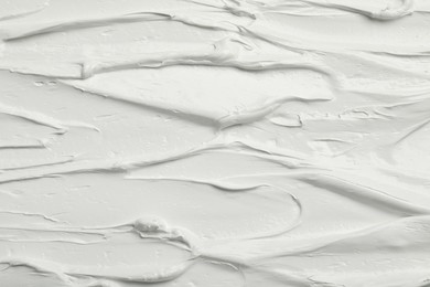 Photo of Texture of white oil paint as background, closeup