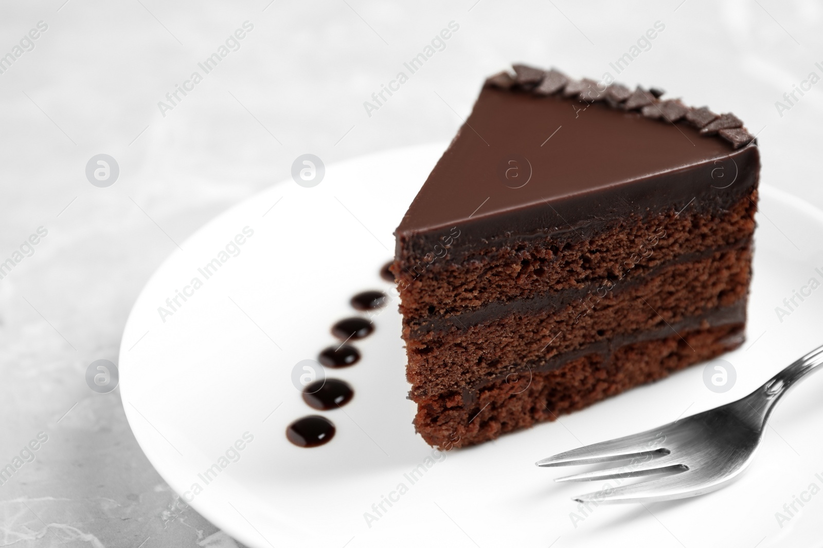 Photo of Piece of tasty chocolate cake served on plate