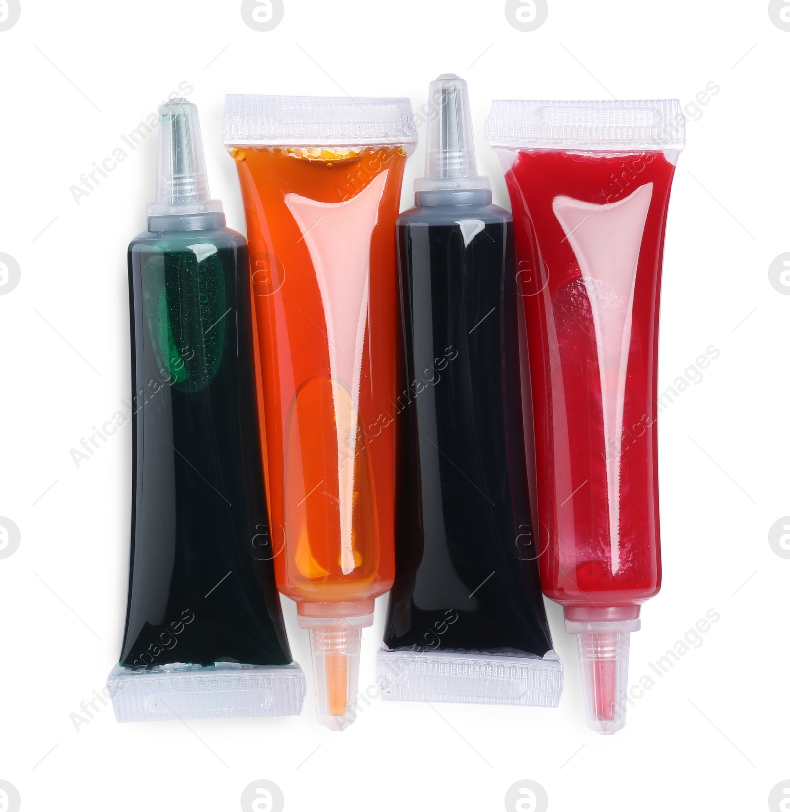 Photo of Tubes with different food coloring on white background, top view