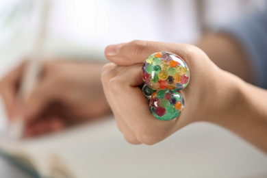Photo of Woman squeezing colorful slime, closeup. Antistress toy