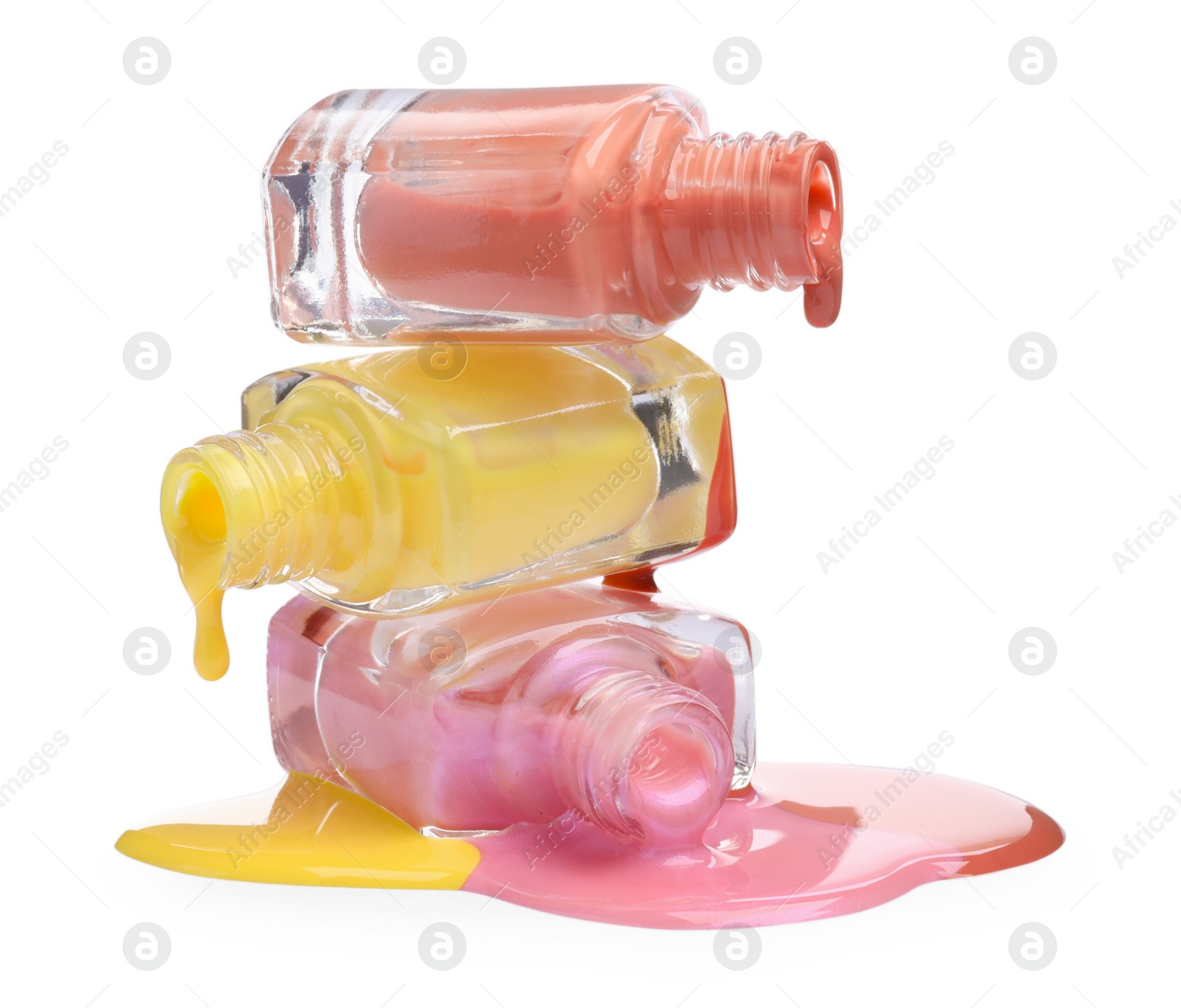 Photo of Color nail polishes dripping from bottles isolated on white