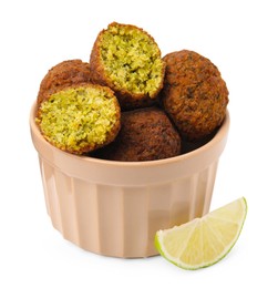 Photo of Delicious falafel balls in bowl and lime slice isolated on white