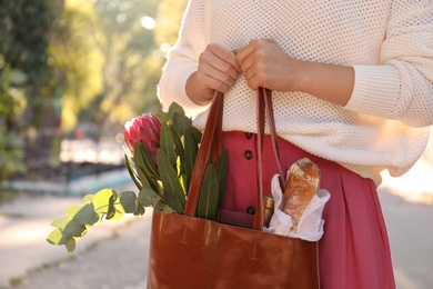 Woman with leather shopper bag outdoors, closeup