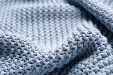 Beautiful light blue knitted fabric as background, closeup