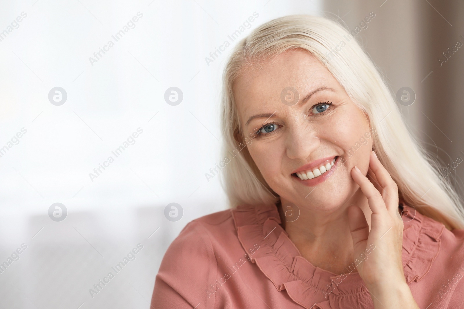 Photo of Portrait of beautiful older woman against blurred background with space for text
