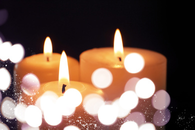 Image of Burning candles on dark background, bokeh effect