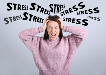 Stressed young woman and text on light grey background