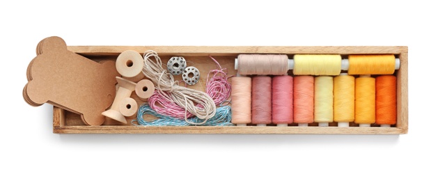 Photo of Container with set of color sewing threads on white background