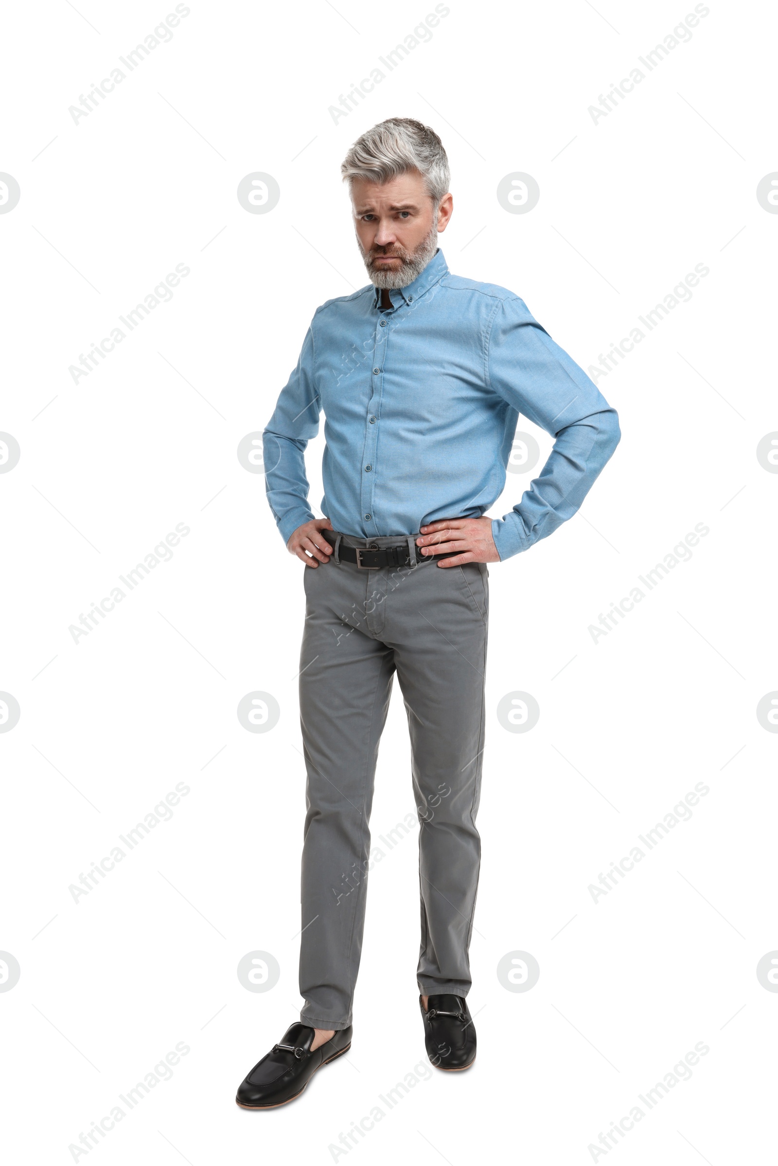 Photo of Mature businessman in stylish clothes posing on white background, low angle view