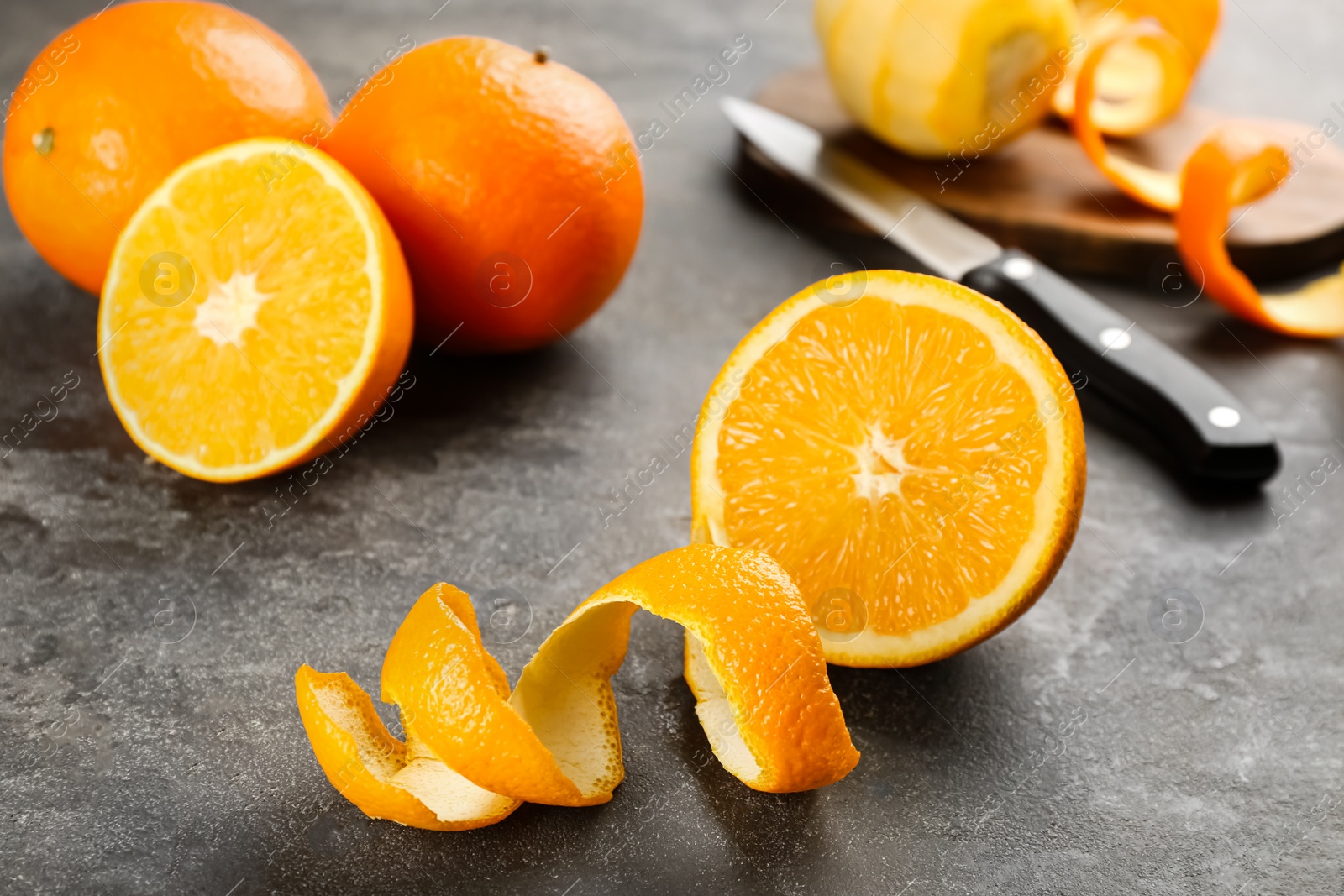 Photo of Orange fruits with peel on grey table