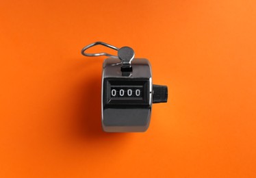 Photo of Modern timer on orange background, top view