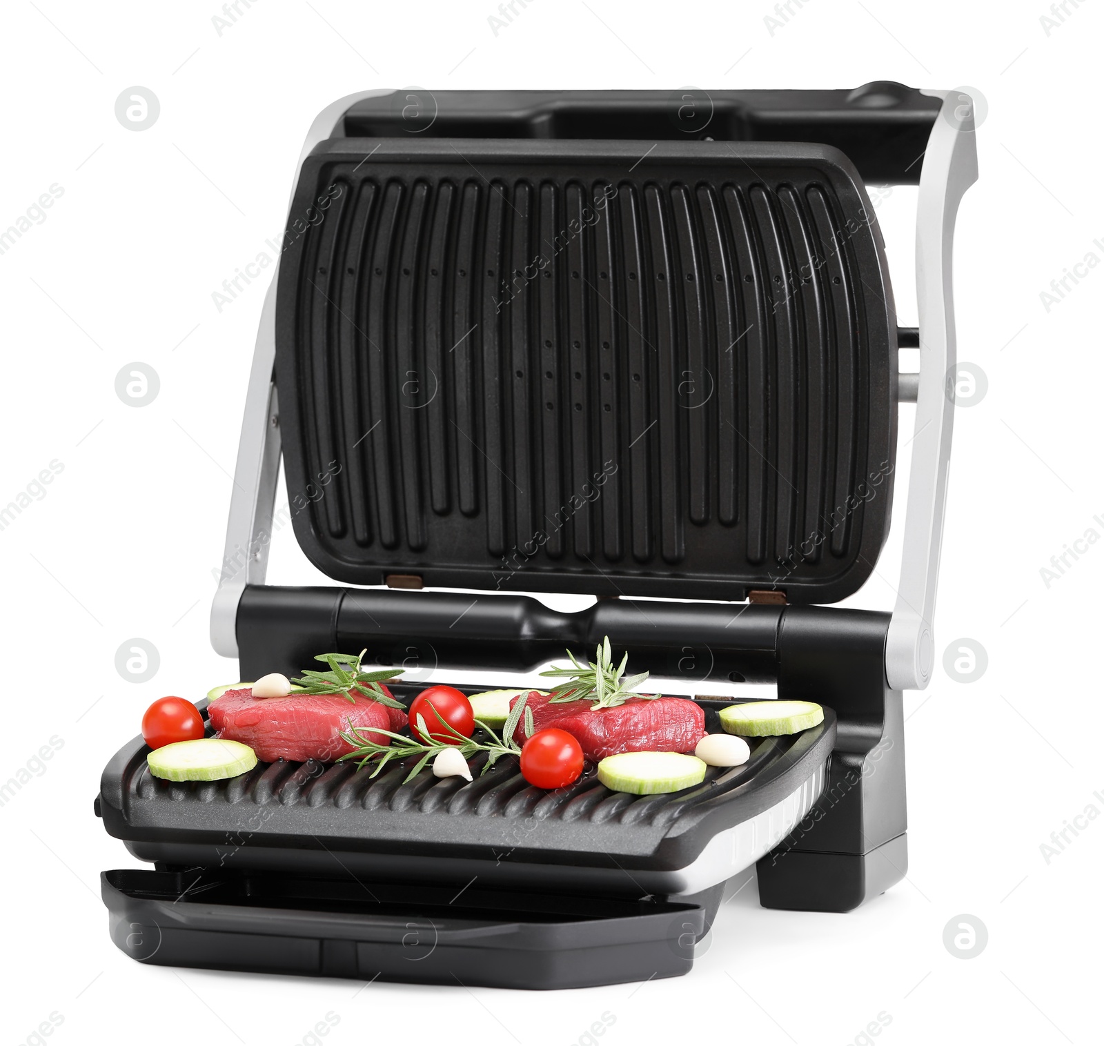 Photo of Electric grill with raw meat, rosemary and vegetables isolated on white