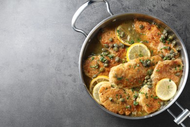 Delicious chicken piccata on grey table, top view. Space for text