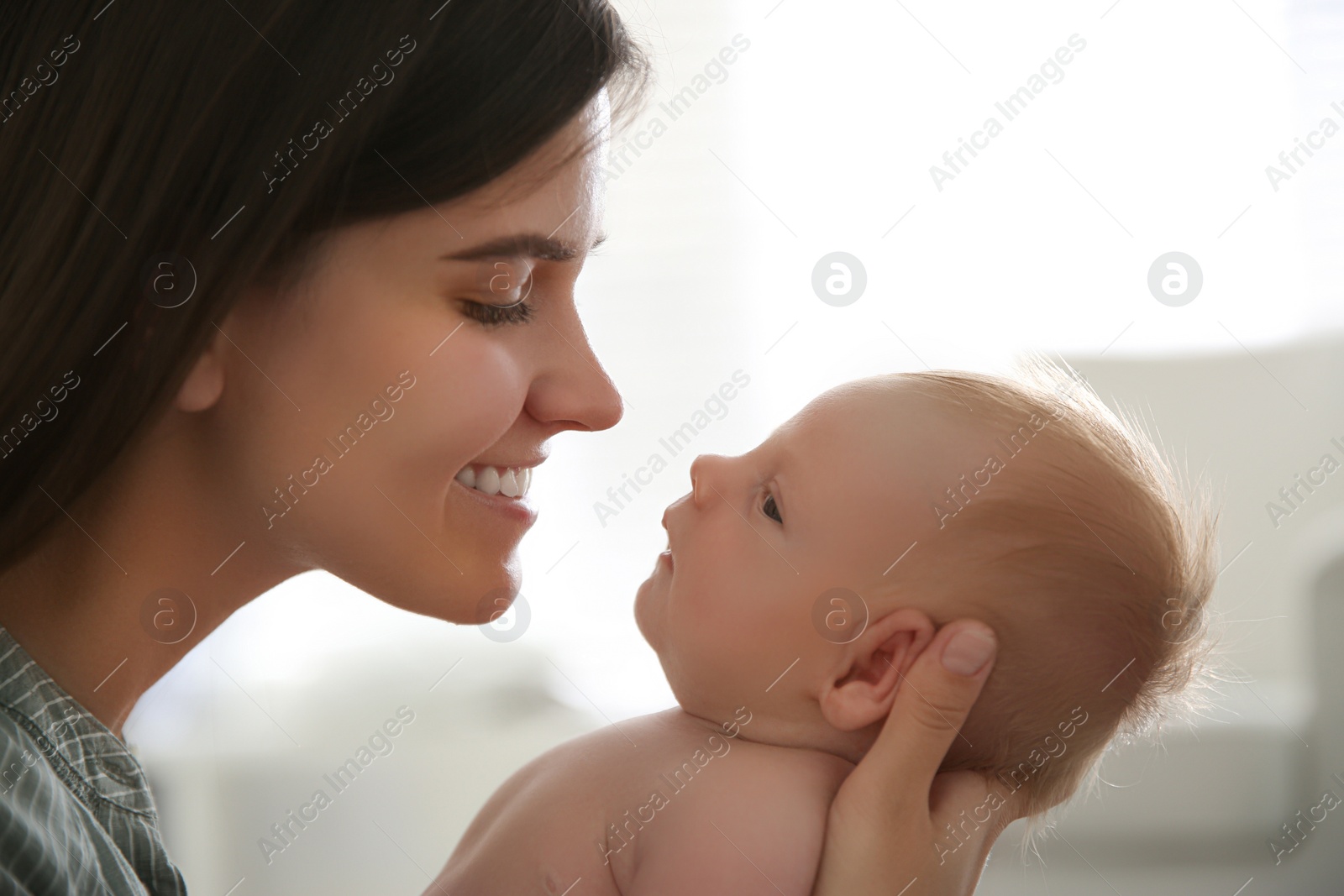 Photo of Mother with her newborn baby at home, closeup