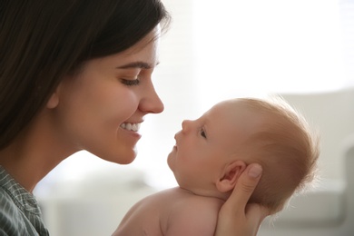 Photo of Mother with her newborn baby at home, closeup