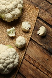 Fresh cauliflower on wooden table. Space for text