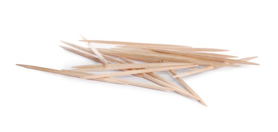 Photo of Heap of wooden toothpicks on white background