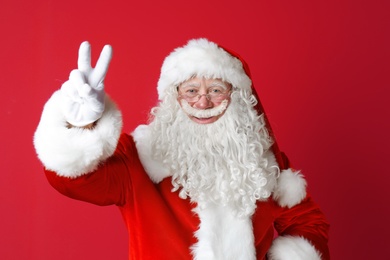 Portrait of authentic Santa Claus on color background