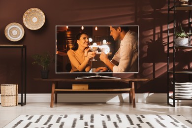 Image of Scene of romantic movie on TV in room