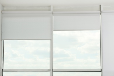 Large window with open roller blinds indoors