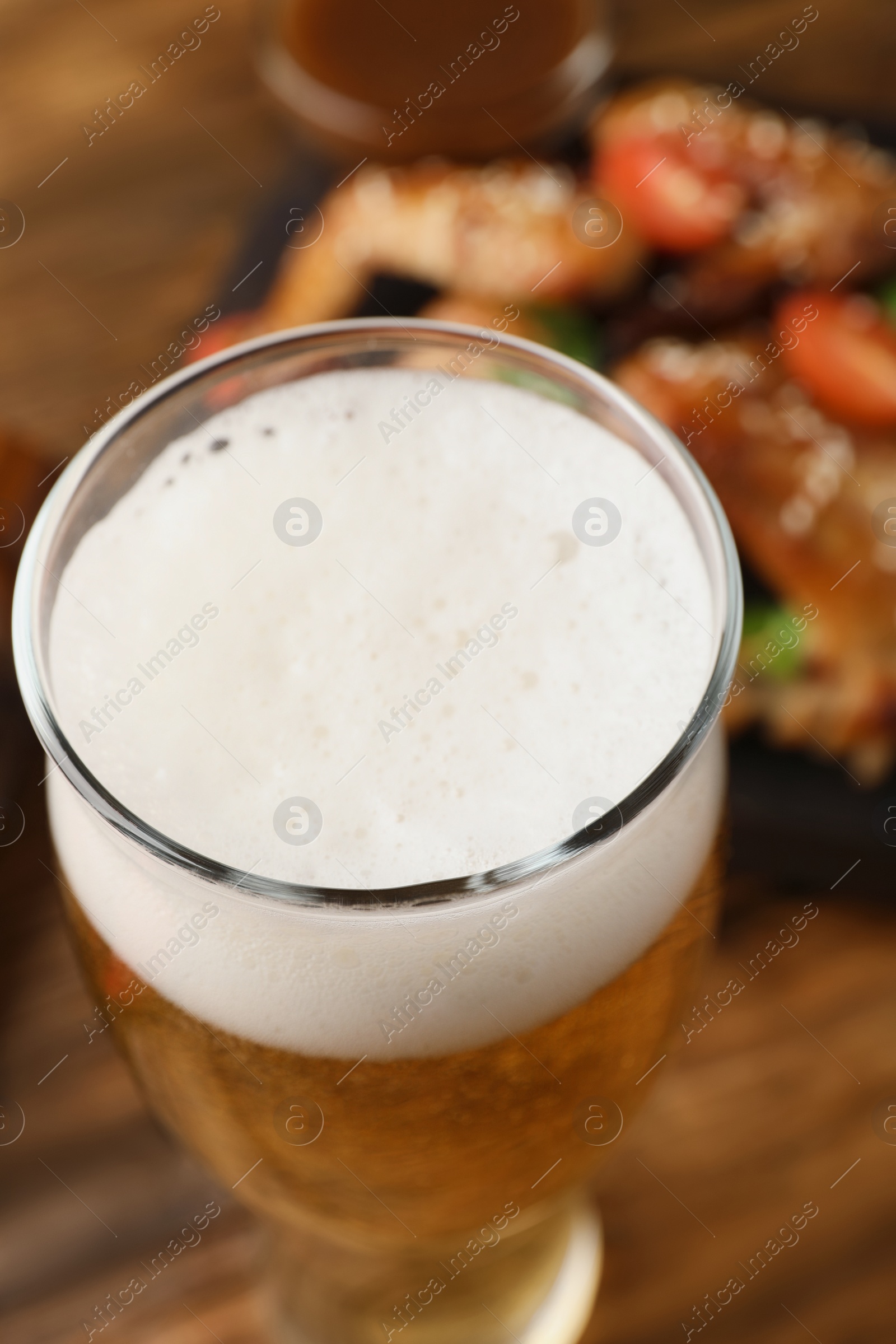 Photo of Glass of fresh beer on table, closeup view