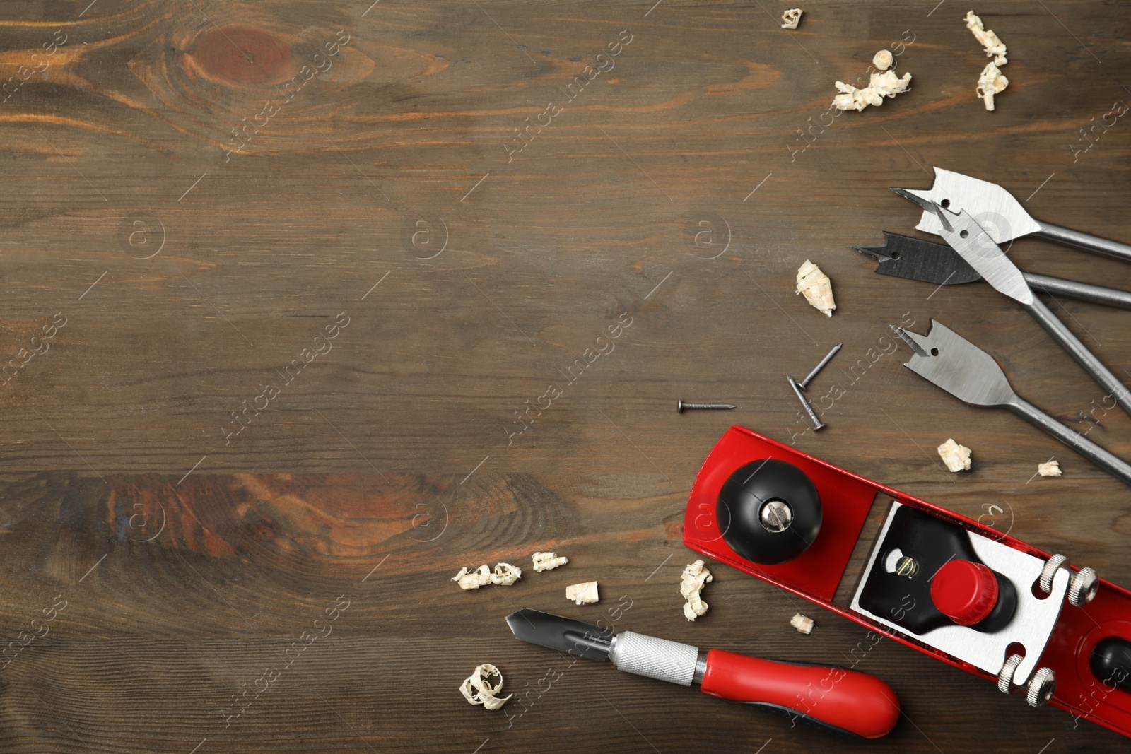 Photo of Flat lay composition with carpenter's tools on wooden background. Space for text