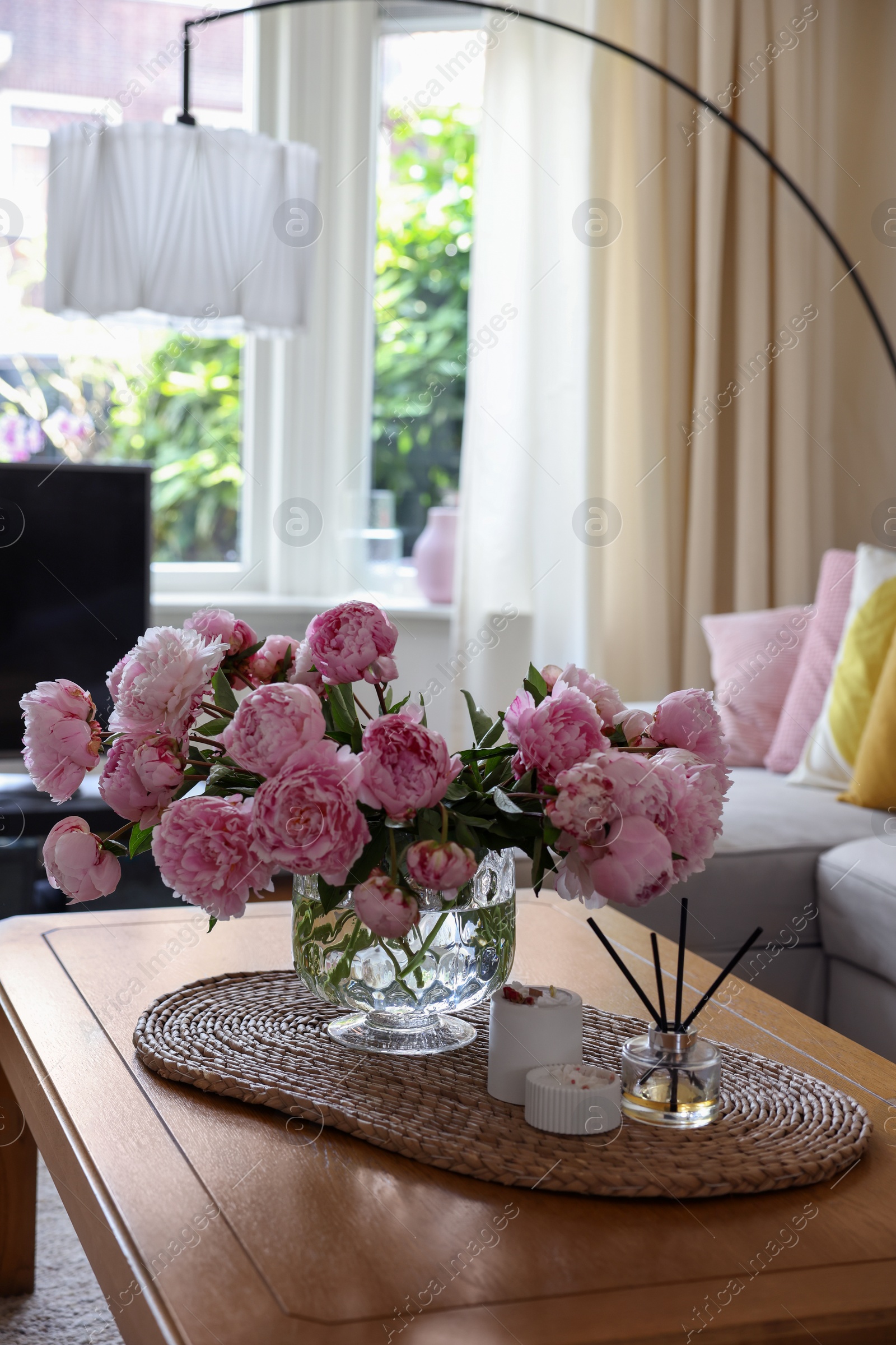 Photo of Beautiful pink peonies in vase on table at home, space for text. Interior design