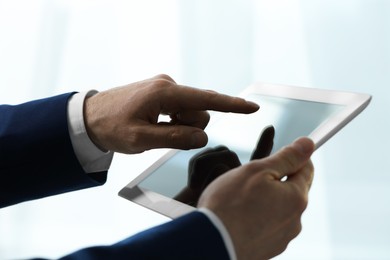 Closeup view of man using new tablet indoors