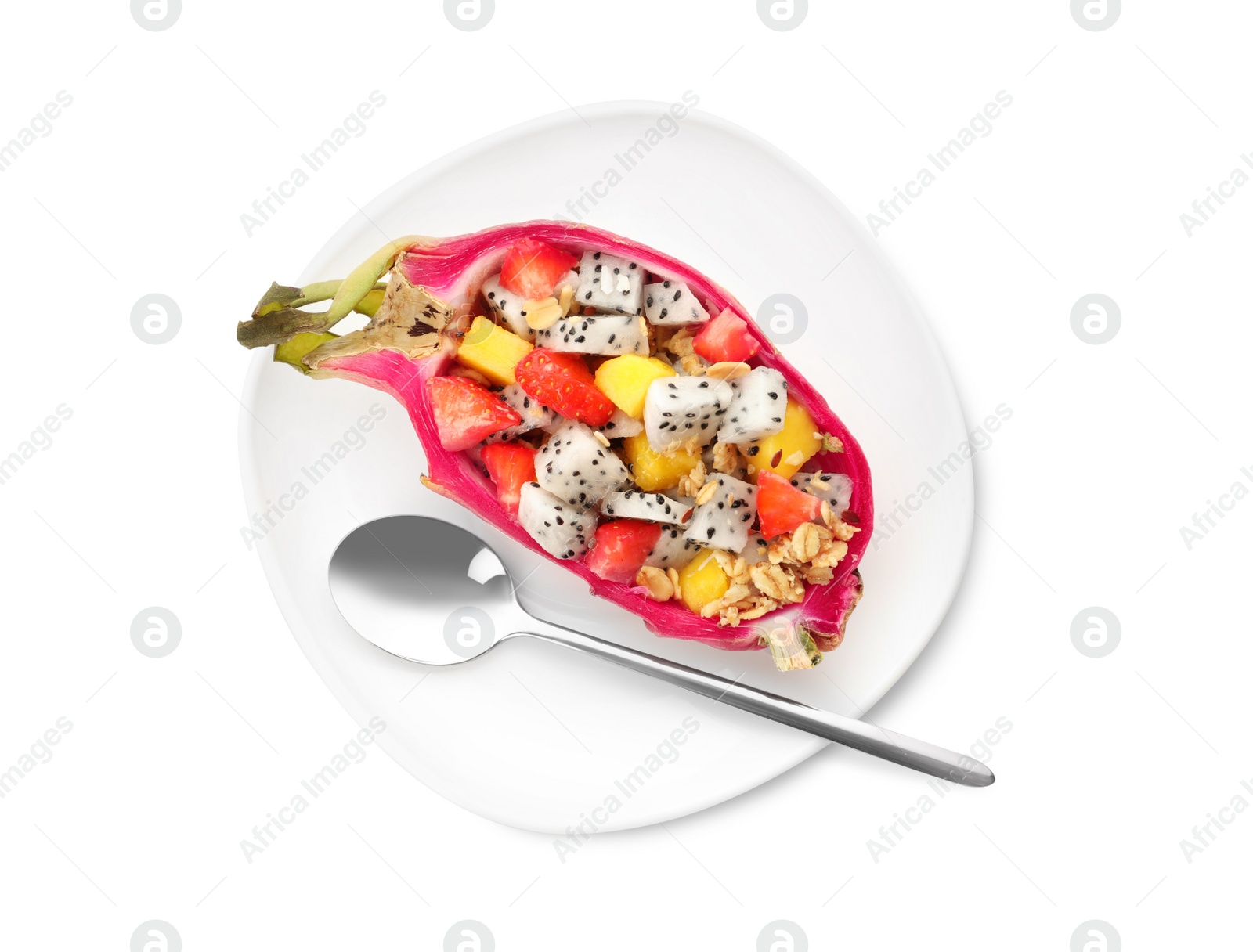 Photo of Yummy pitahaya boat with mango, granola and strawberry near spoon on white background, top view