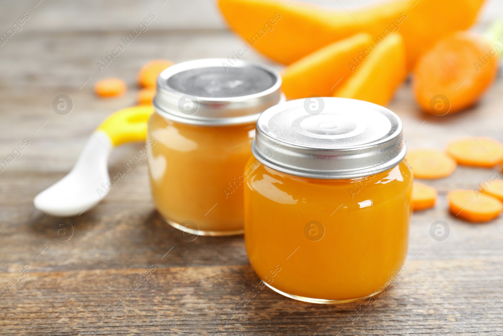 Photo of Jars with tasty baby food on table