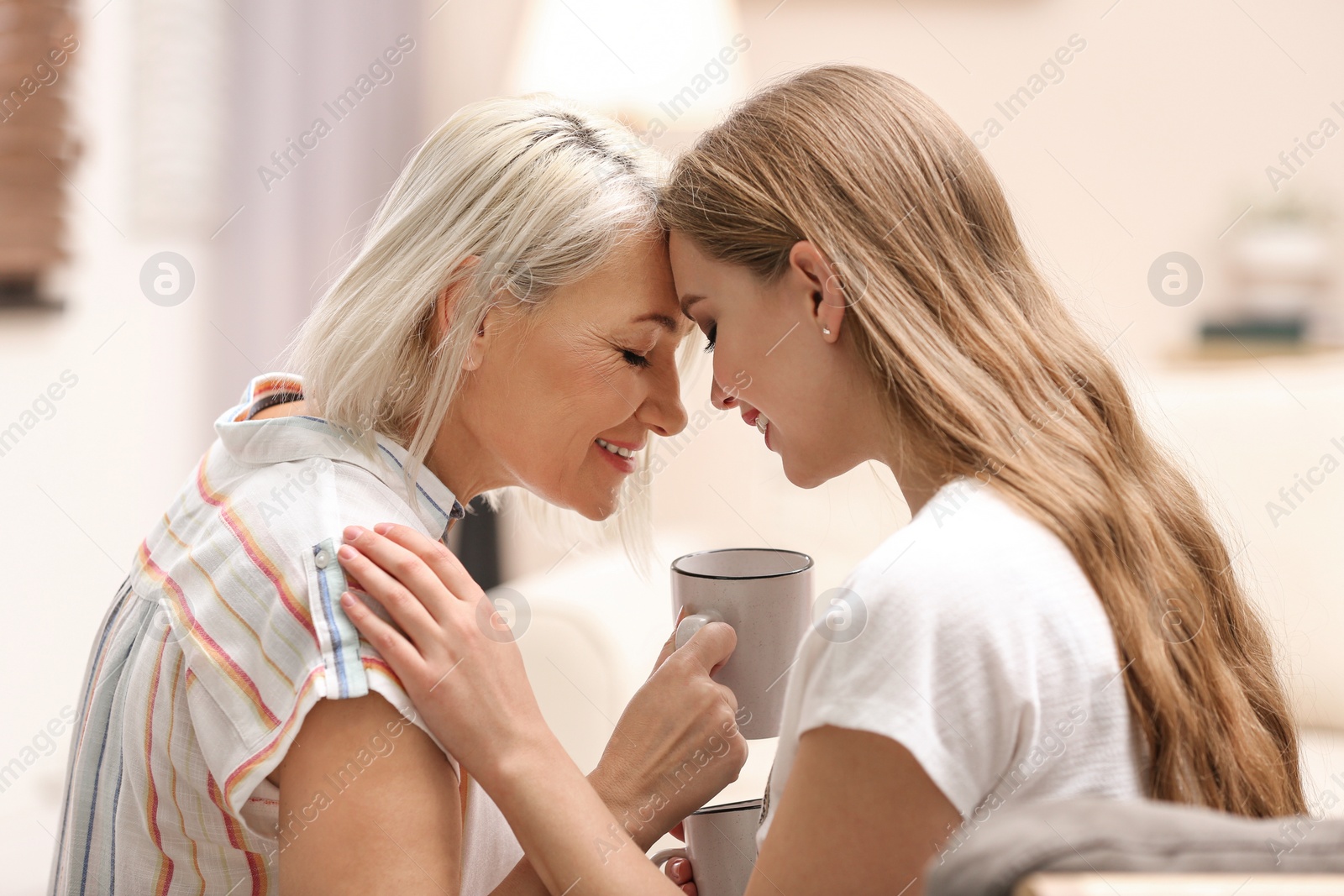 Photo of Mother and her adult daughter spending time together at home