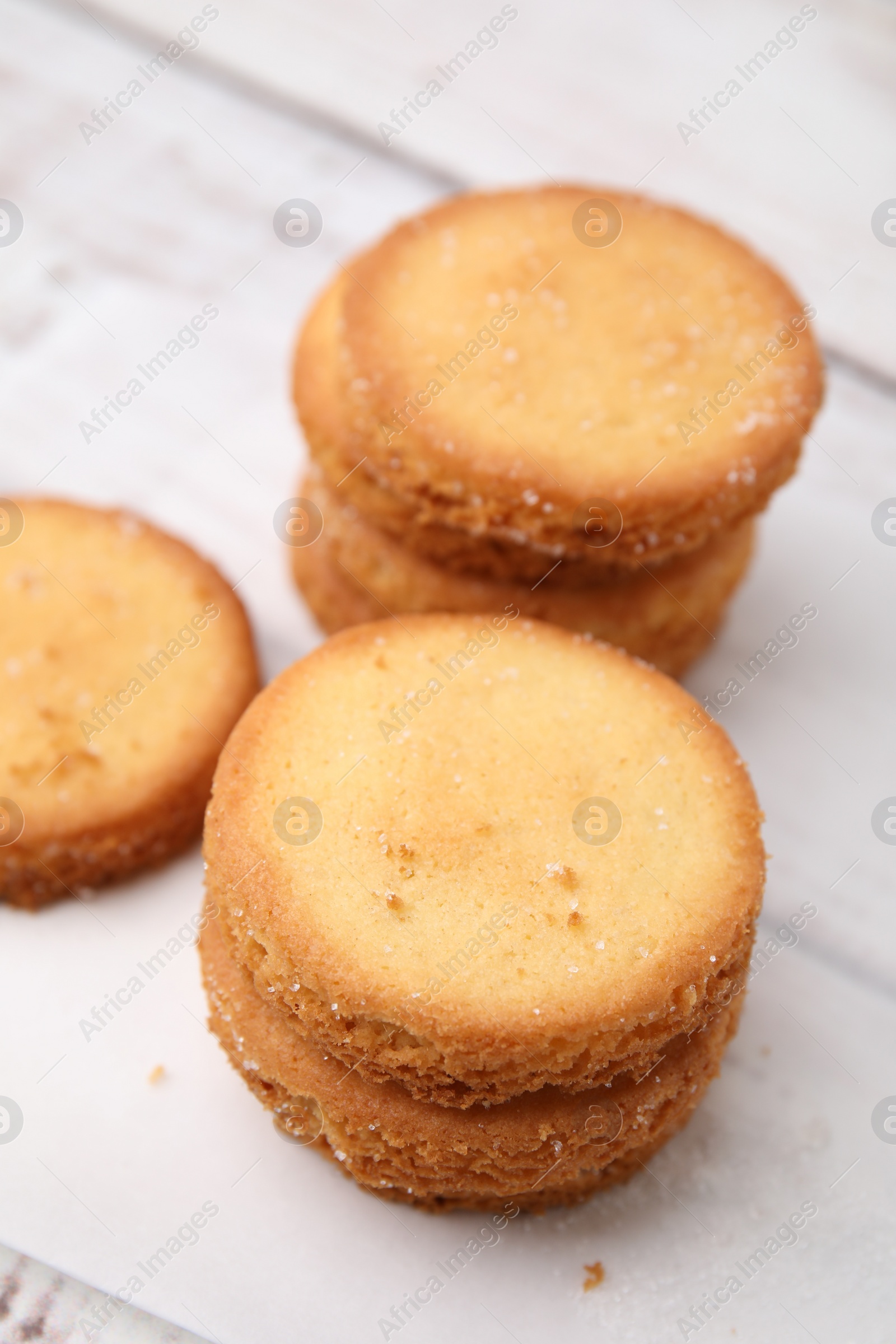 Photo of Tasty sweet sugar cookies on white wooden table, closeup