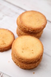 Photo of Tasty sweet sugar cookies on white wooden table, closeup