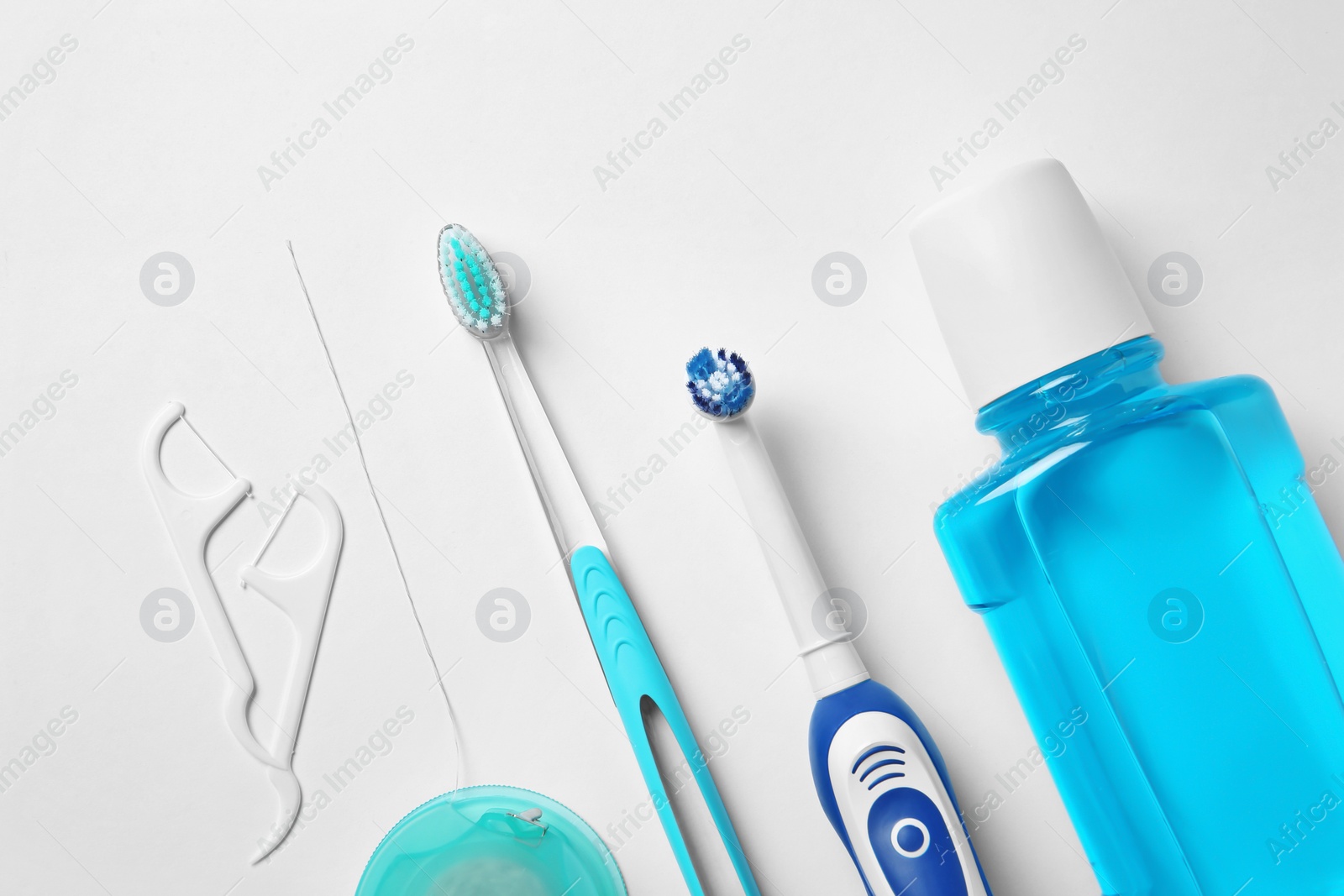 Photo of Flat lay composition with toothbrushes and oral hygiene products on white background