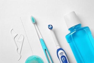 Photo of Flat lay composition with toothbrushes and oral hygiene products on white background