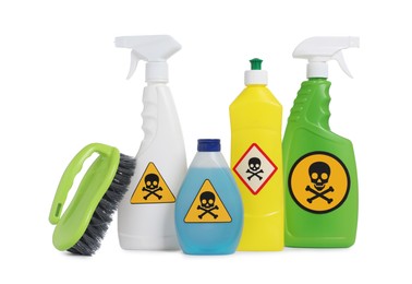 Photo of Bottles of toxic household chemicals with warning signs and brush on white background