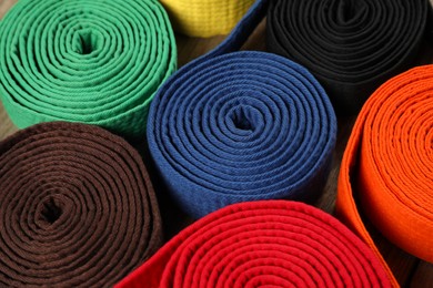 Colorful karate belts, closeup. Martial arts uniform