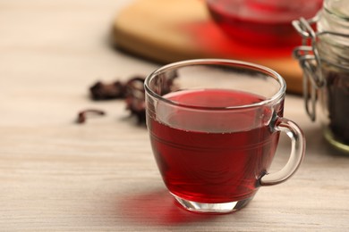 Delicious hibiscus tea on white wooden table