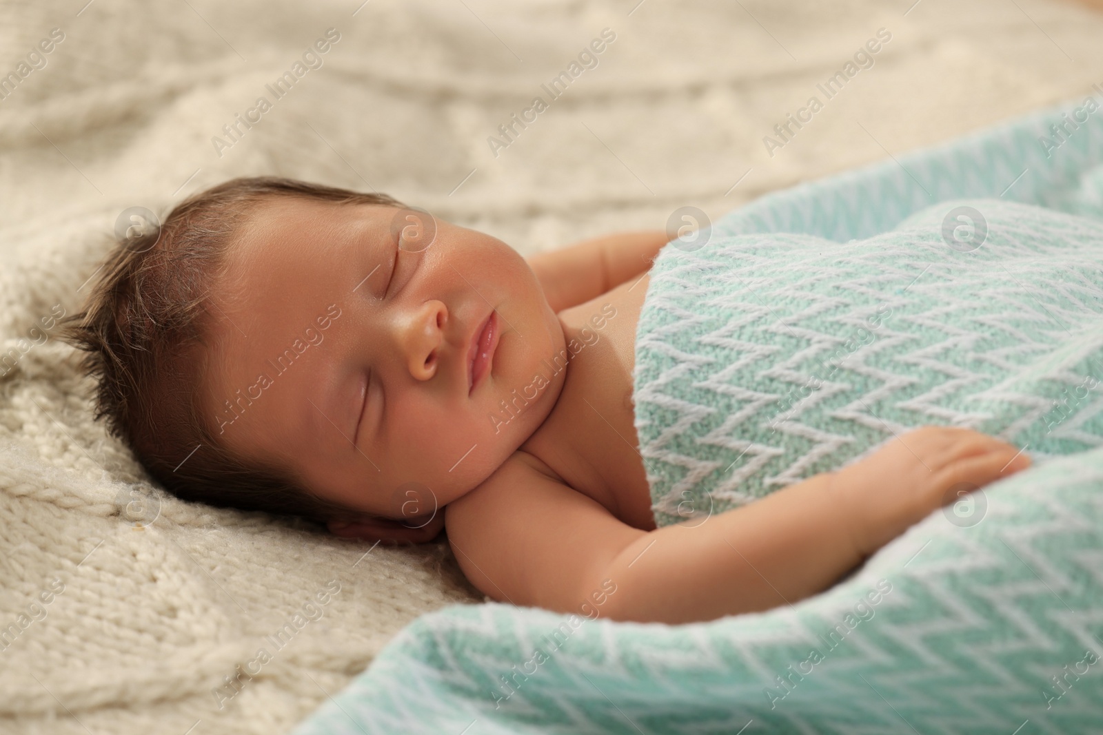 Photo of Cute newborn baby sleeping on beige blanket, closeup