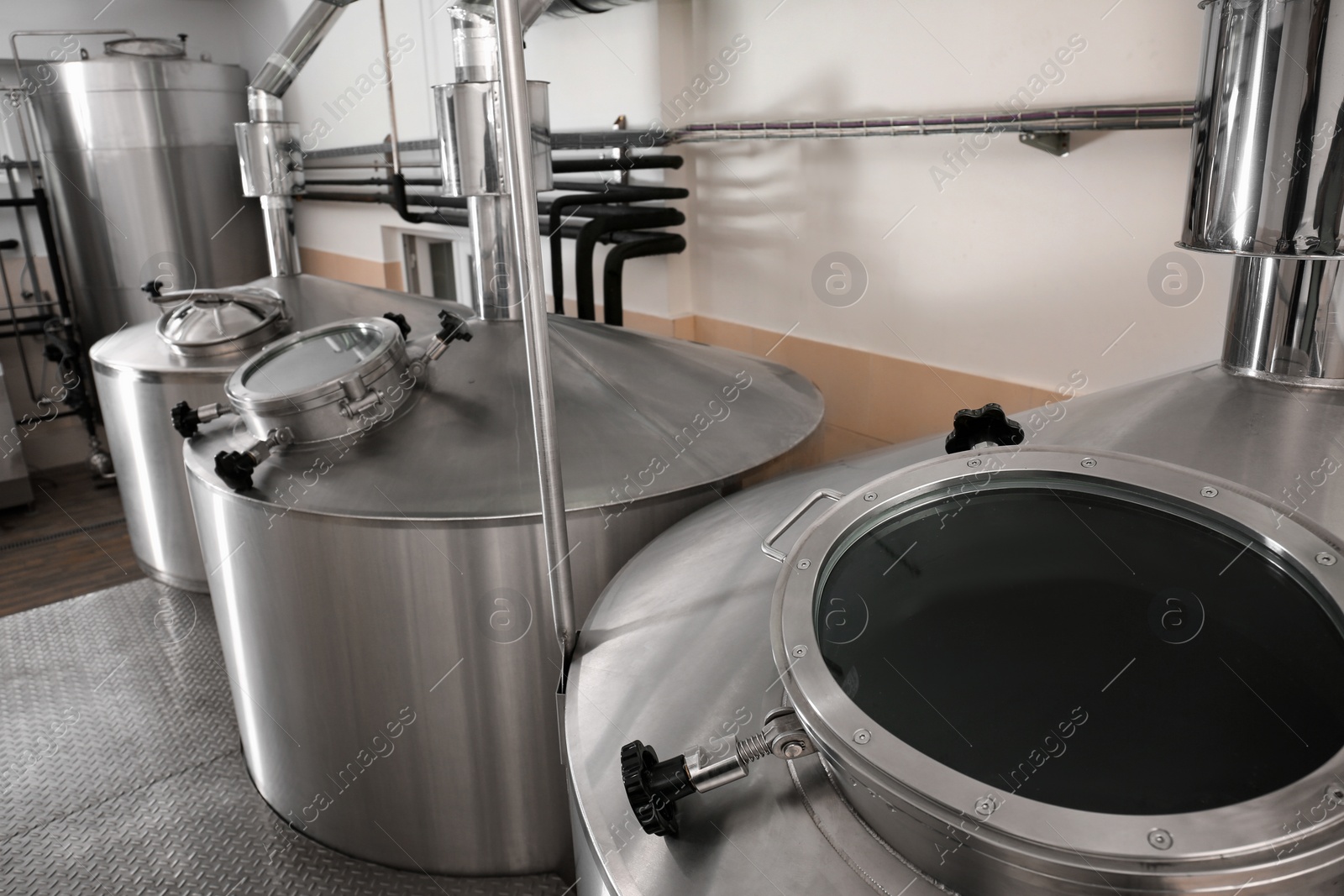 Photo of Steel tanks for beer fermentation in brewhouse