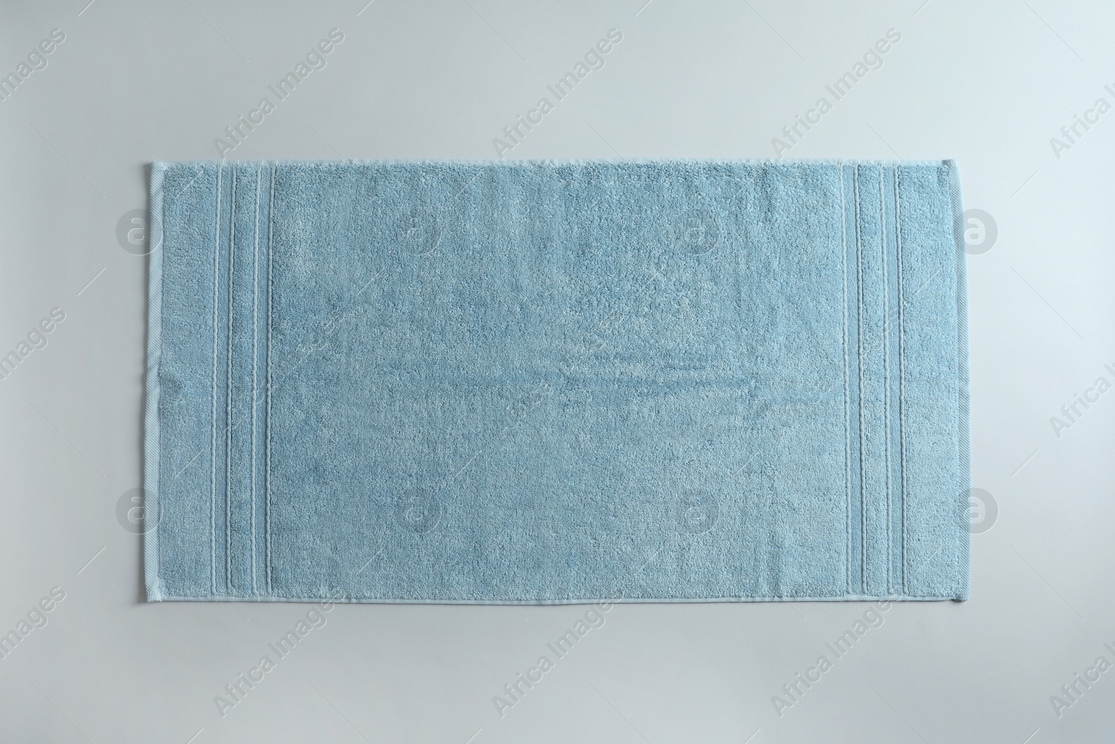 Photo of Fresh fluffy towel on grey background, top view. Mockup for design