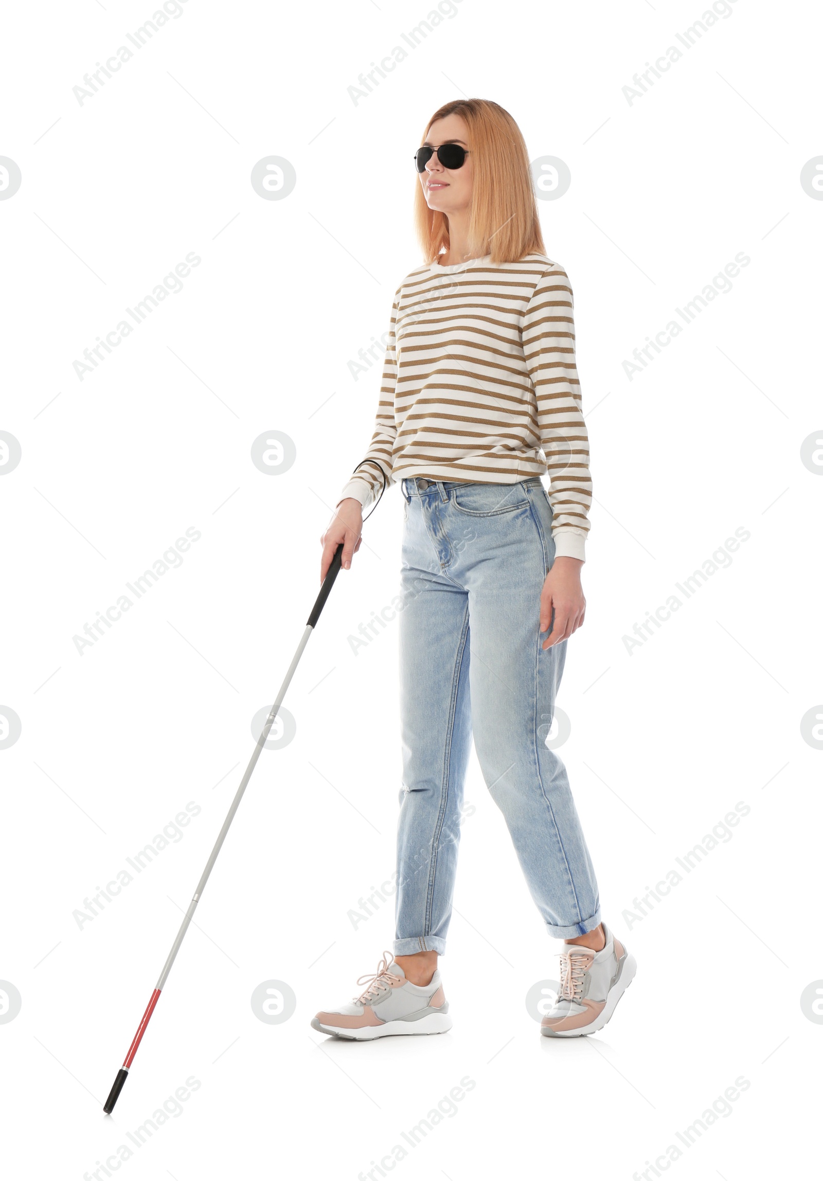 Photo of Blind person with long cane walking on white background