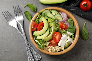 Photo of Delicious avocado salad with quinoa on grey table, flat lay