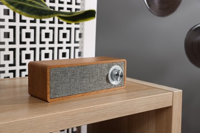 Photo of Portable speaker on wooden table in teenager's room