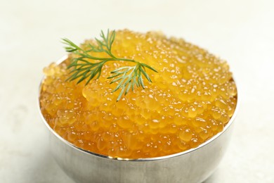 Fresh pike caviar in bowl on light table, closeup