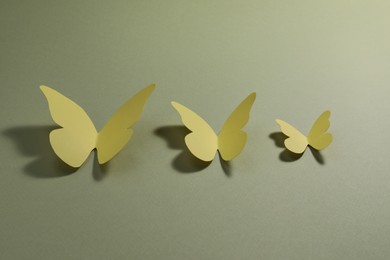 Yellow paper butterflies on pale green background