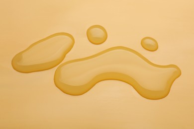 Photo of Puddle of water on pale orange background