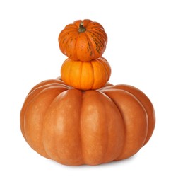 Photo of Stack of fresh ripe pumpkins on white background