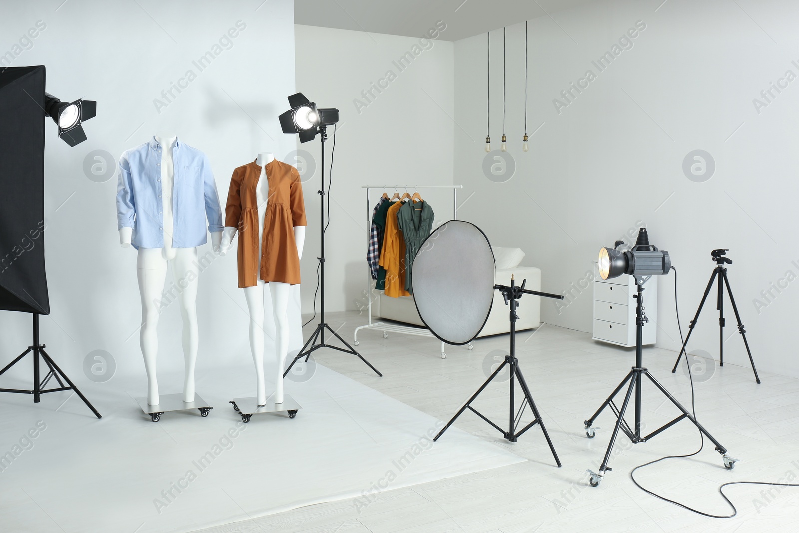 Photo of Ghost mannequins with modern clothes in professional photo studio