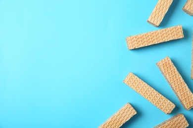 Photo of Flat lay composition with delicious crispy wafers on blue background. Space for text